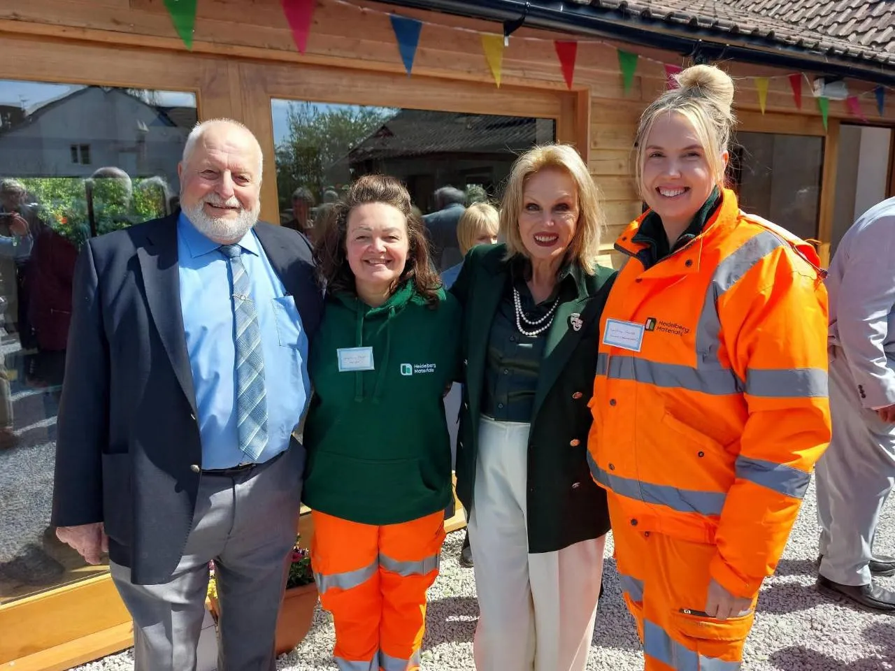Dame Joanna Lumley with representatives of Batts Combe quarry and haulier Arnold Webber outside the Hub
