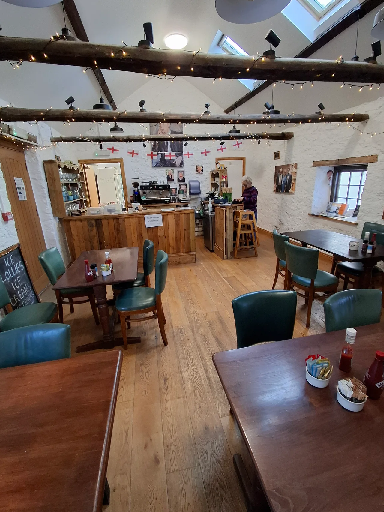 The timber beams, stone walls and wooden tables inside the Hub & Café