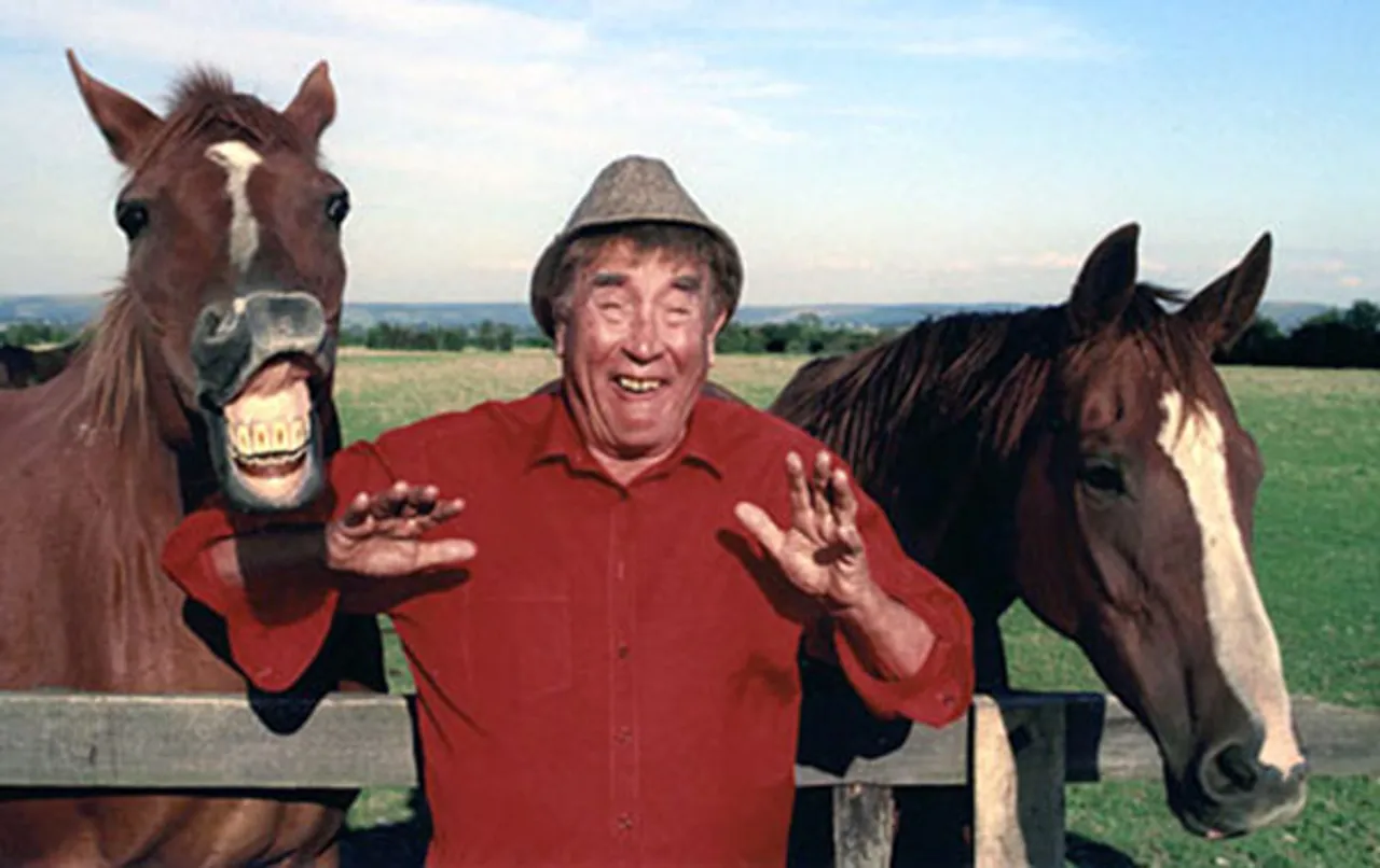 Frankie Howerd pictured with two horses